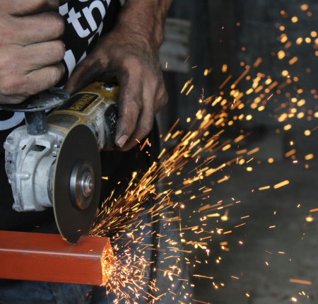 worker using routing to cut metal